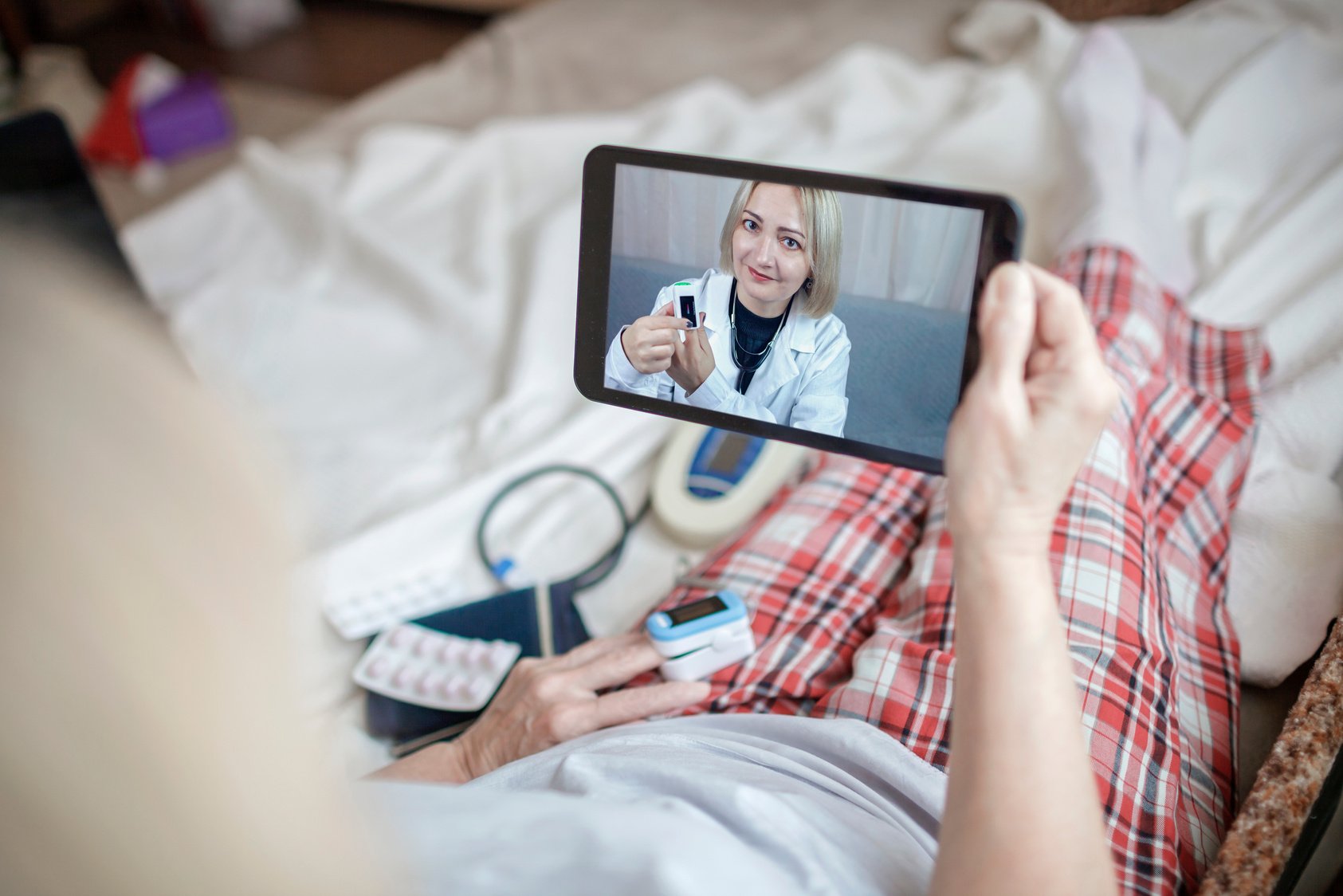 Old Woman in Bed Having Medical Teleconsultation